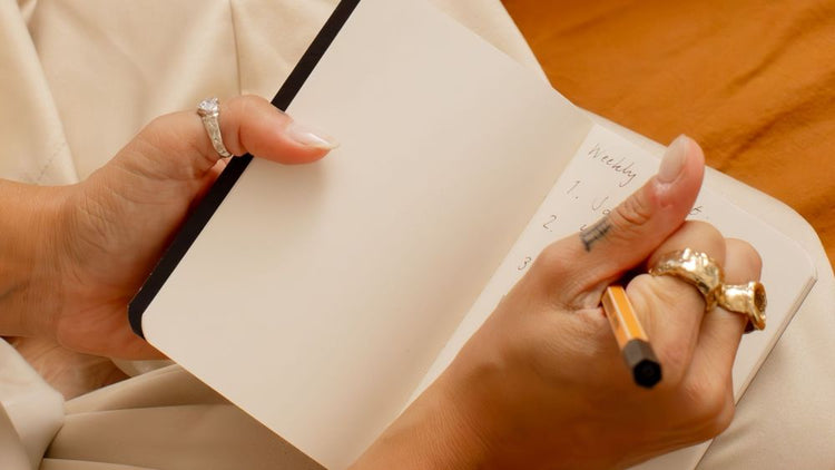 a person writing in a journal
