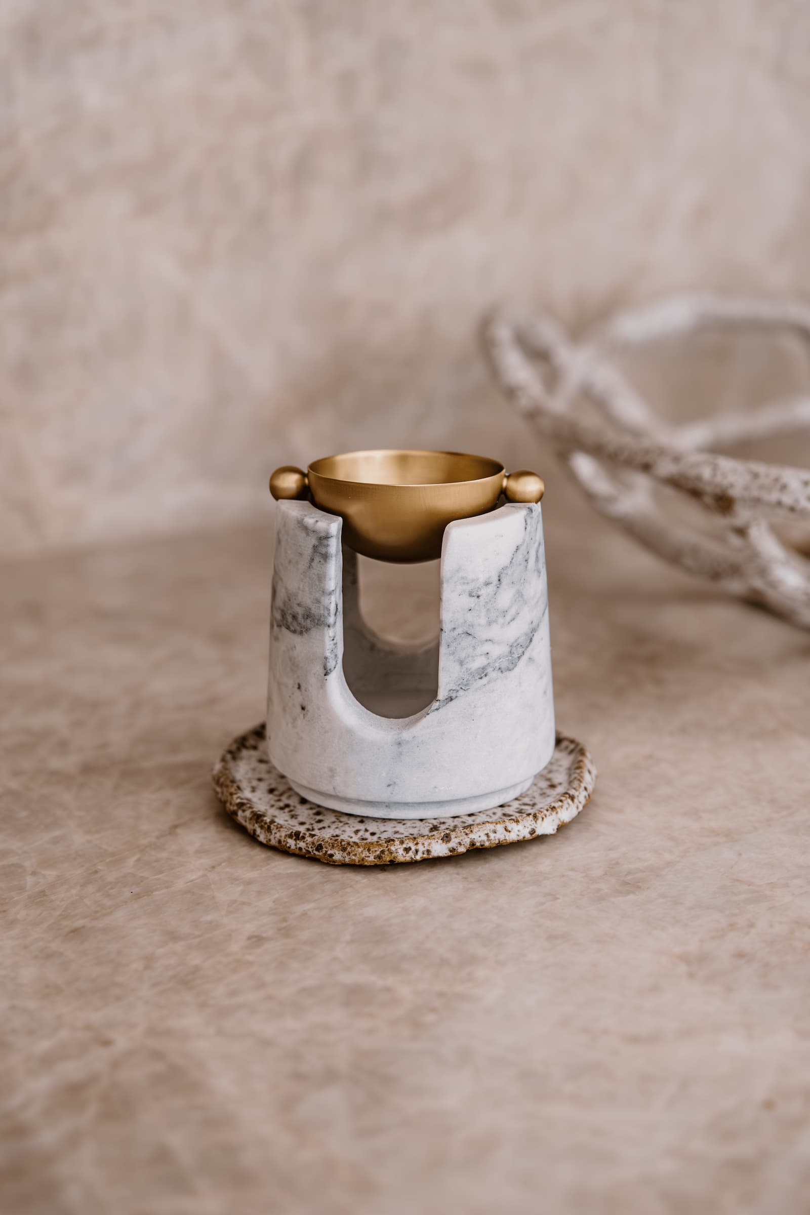 a marble oil burner in neutral earthy setting